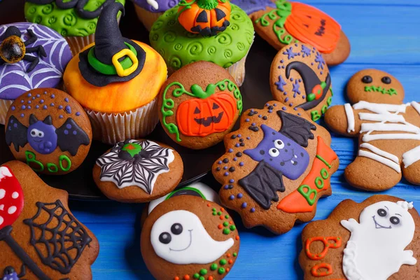 Halloween dessert: funny monsters, ghosts and pumpkins made of b