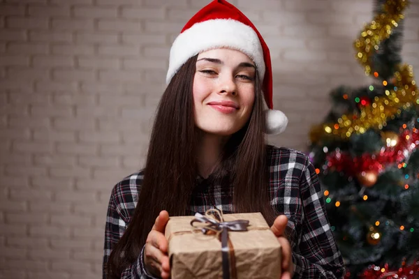 Young beautiful happy woman in Santa cap with a gift box on chri — Stock Photo, Image