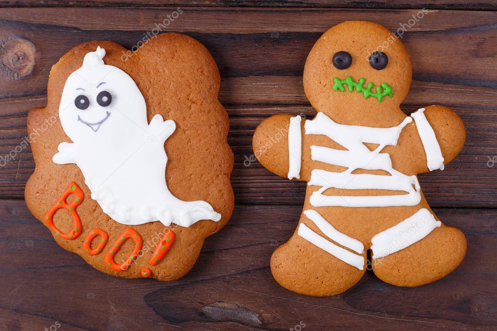 Funny homemade Halloween ginger cookies with ghost and mummy, cl