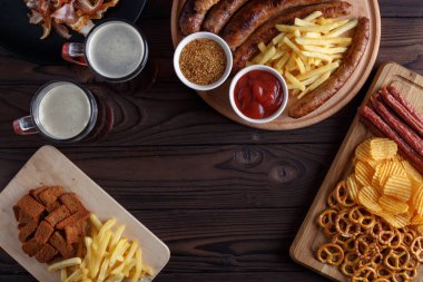 Karanlık bira ve iştah açıcı bira aperatifler ayarlayın. İki kupalar o Üstten Görünüm