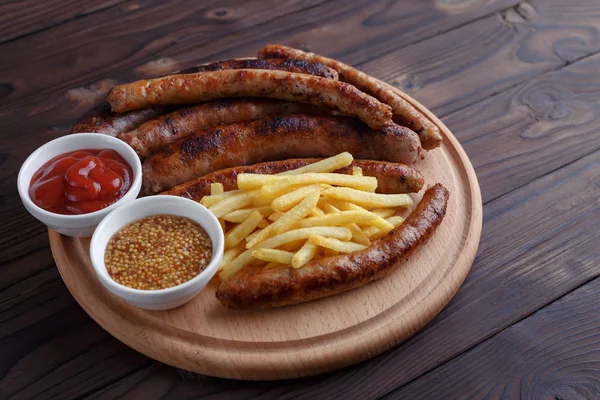 Appetizing beer snacks set. Assorted grilled sausages and french