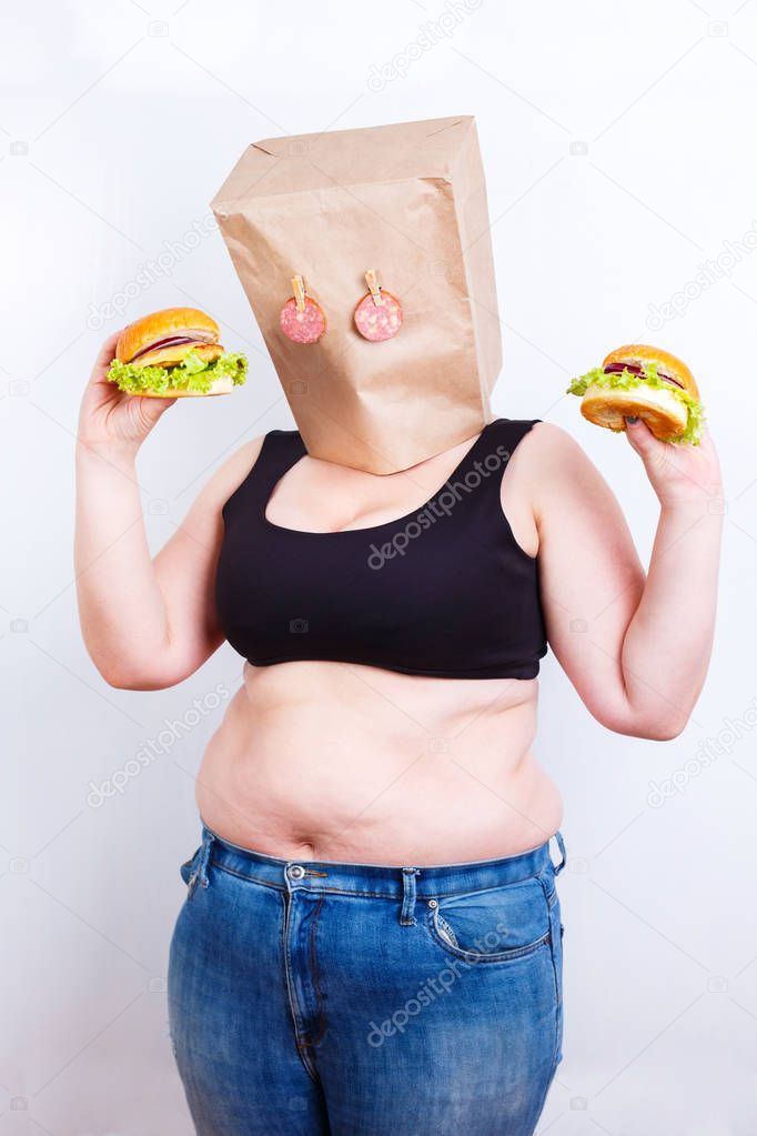 Obese fat  woman with a paper bag on head like a mask with eyes 