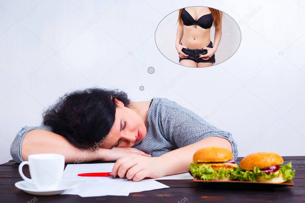 Overweight obese woman with junk food sleeping and dreaming of f