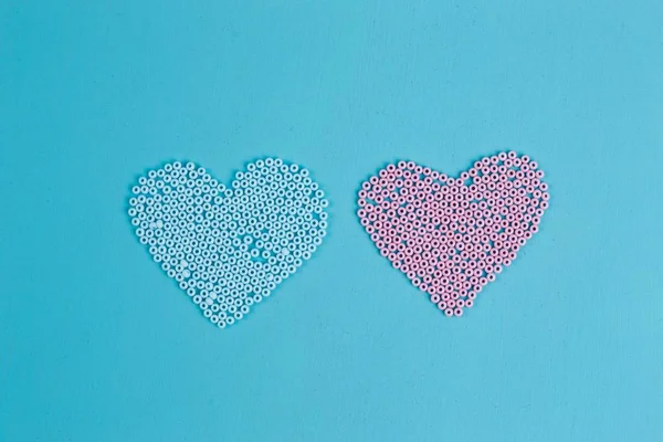 Pink and blue hearts of beads, copy space. Love, couple, boy and