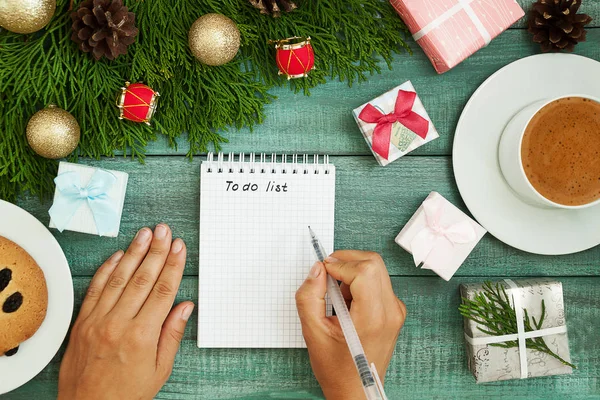 Christmas wish list writing. Woman creating present list for win