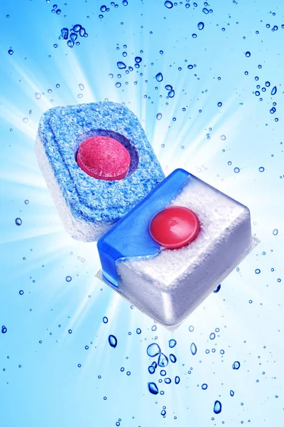 Two dishwasher detergent tablet under blue water