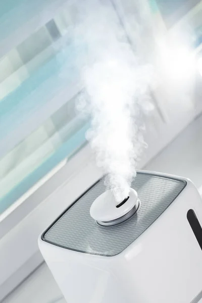 El humidificador blanco ultrasónico sobre la ventana humedece el aire seco — Foto de Stock