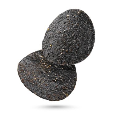 Beyaz arka planda izole edilmiş iki siyah patates cipsi. Makro çekim.