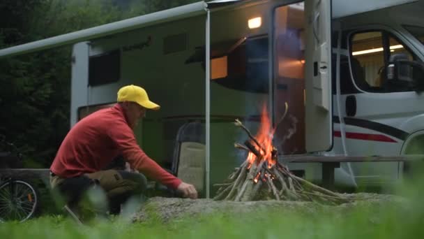17 de septiembre de 2019. Hombre Burning Camp Fire delante de su autocaravana Van — Vídeos de Stock