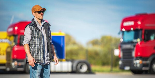 Transportation Industry. Caucasian Male Semi Truck Driver in His 30s on the Truck Stop.