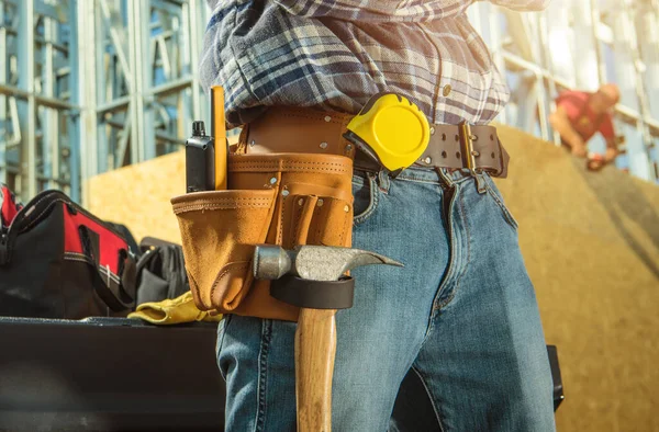 Construction Contractor Ready For His Job. Skeleton Steel of Residential Building in Background. Construction Industry Theme.