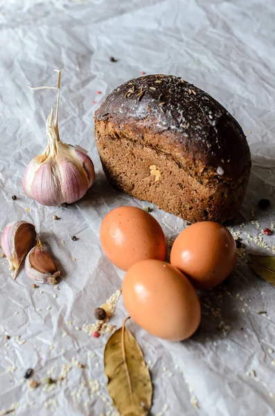 Csendélet, kenyér, tojás, fokhagyma és fűszerek. — Stock Fotó