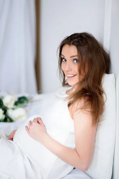 Menina grávida com tatuagem em um vestido branco . — Fotografia de Stock