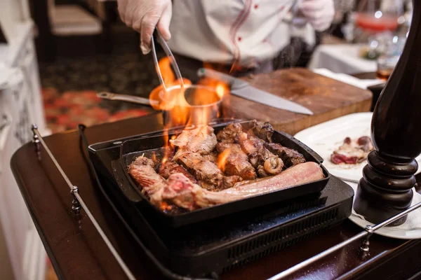 Hand of grilling some meat and meat ball on hot flame.. — Stock Photo, Image