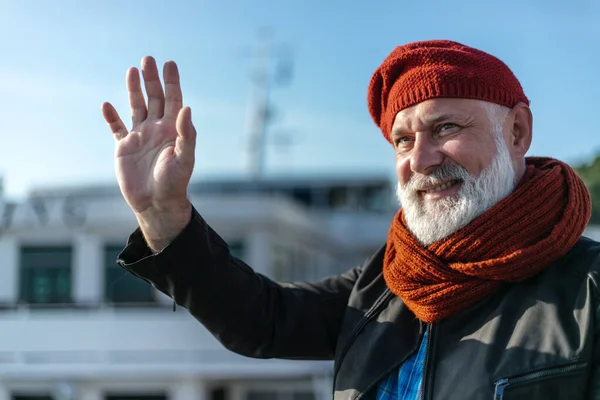 Delighted pensioner waving goodbye stock photo