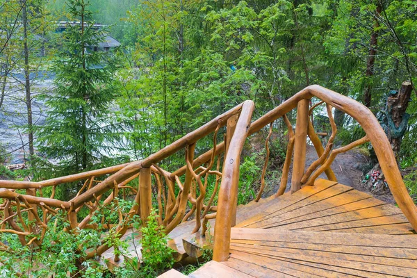 Carved wooden staircase in a forest and lake — Stock Photo, Image