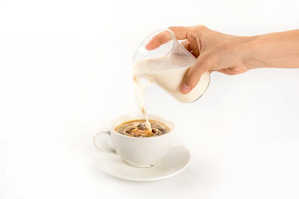 Pouring milk into coffee — Stock Photo, Image