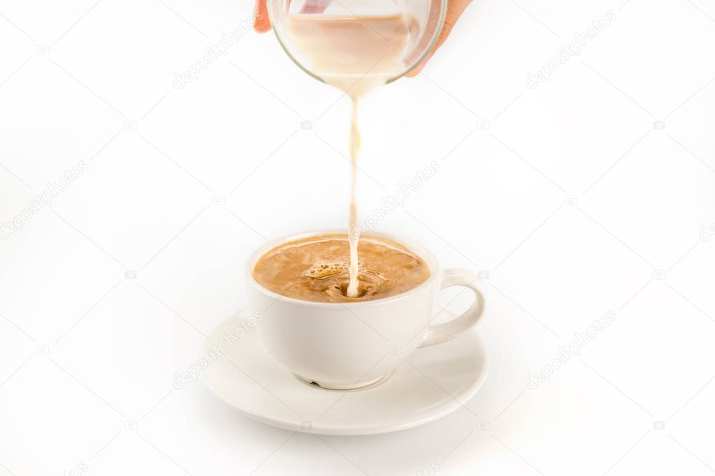 Pouring milk into coffee 