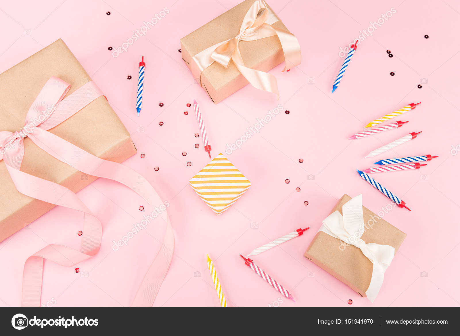 Candles with gift boxes and confetti Stock Photo by ©VikaKhalabuzar