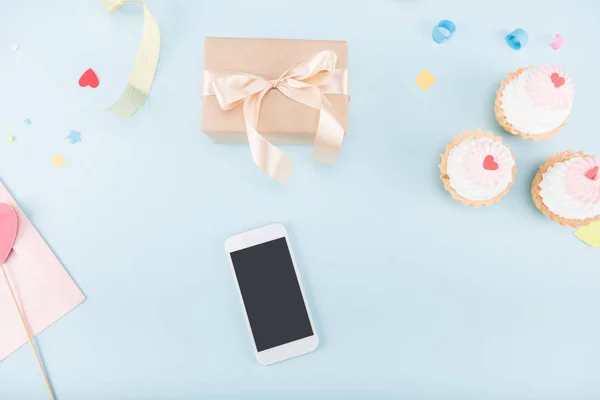 Sütemények, smartphone és ajándék doboz — Stock Fotó