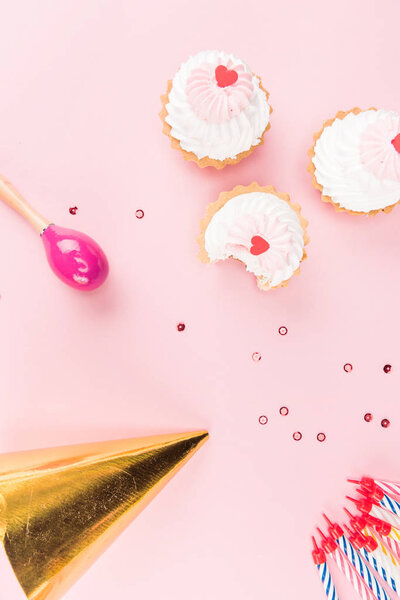 cakes with candles and party hat