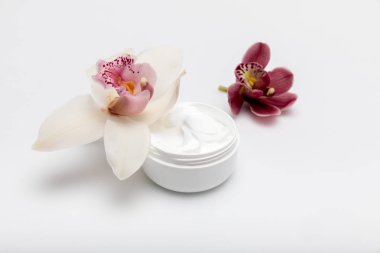 Organic cream with orchids clipart
