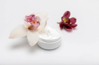 Organic cream with orchids clipart