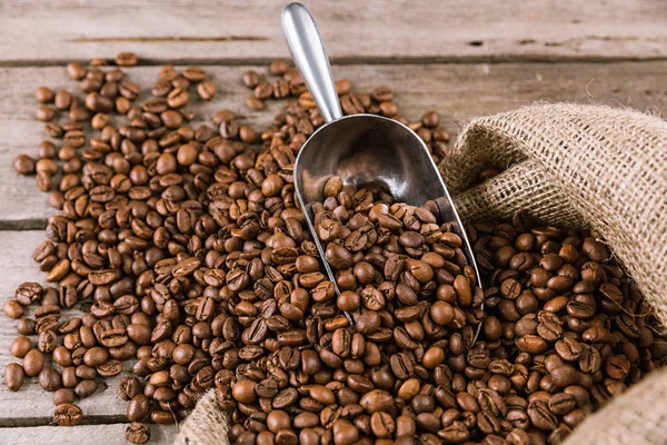 Coffee beans and scoop — Stock Photo