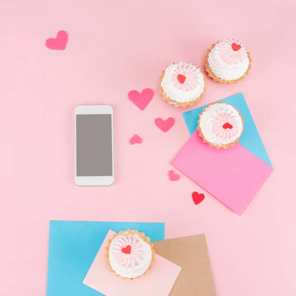 Deliciosos cupcakes e smartphone — Fotografia de Stock