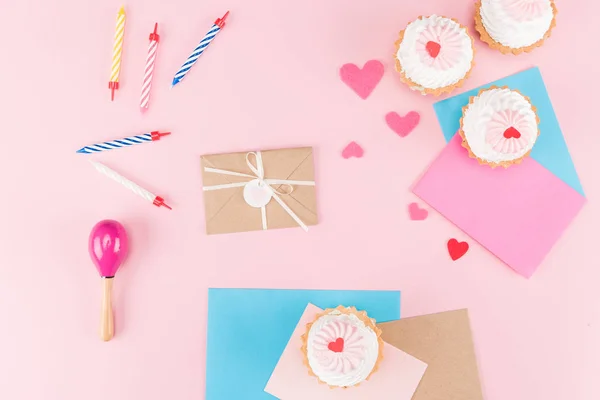 Cupcakes and colorful candles — Stock Photo