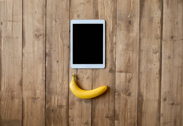 Banana and digital tablet — Stock Photo