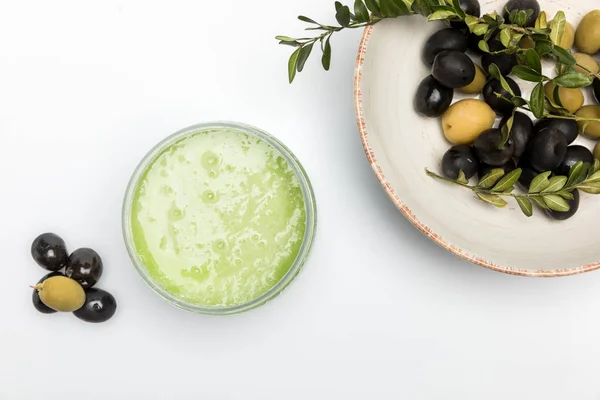 Organic cream and olives — Stock Photo