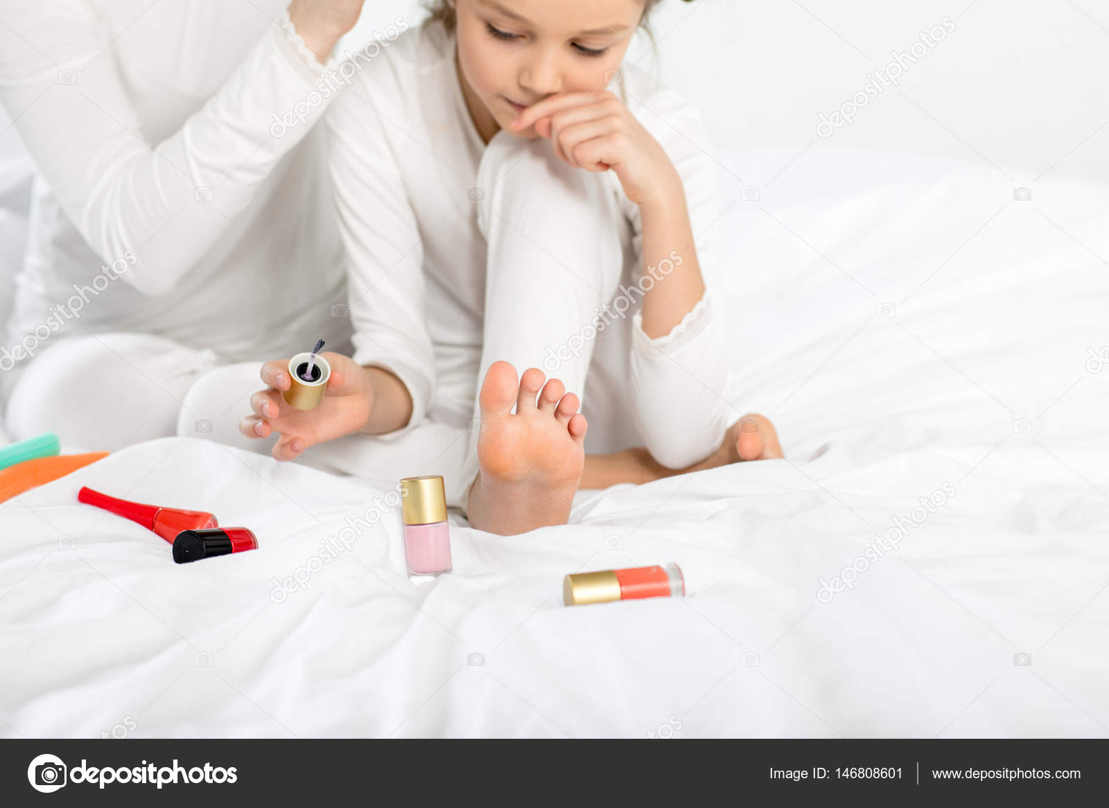 Girl applying nail polish Stock Photo by ©YuraSokolov 146808601