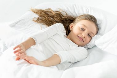 Adorable girl in bed clipart