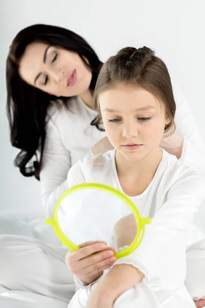 Mother combing hair of daughter — Stock Photo, Image