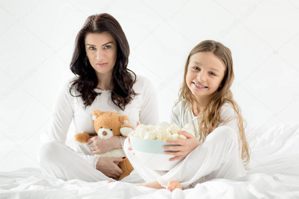 Daughter and mother with marshmallow