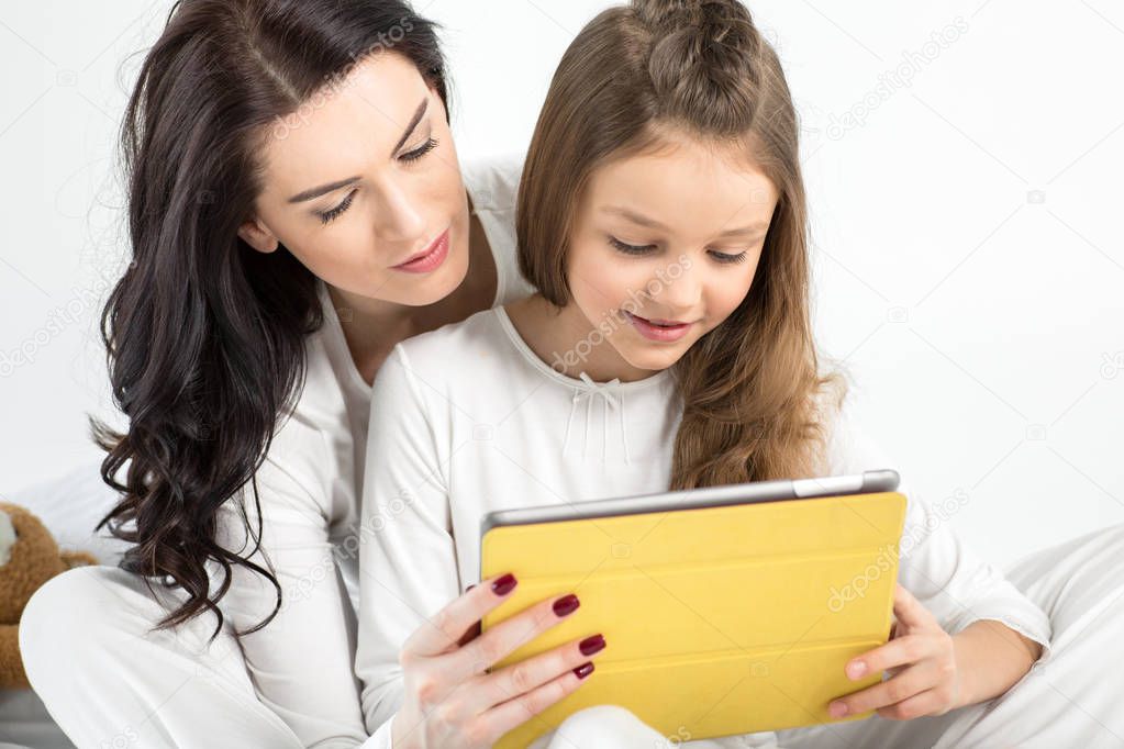 Mother and daughter with digital tablet 