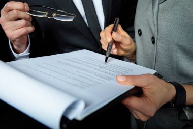 Businesspeople signing papers  clipart