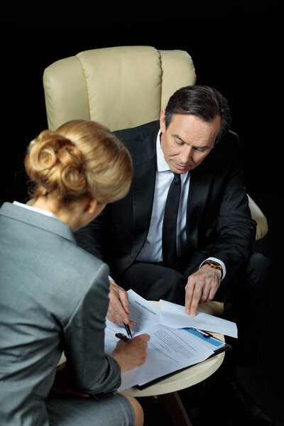 Businesspeople signing papers 