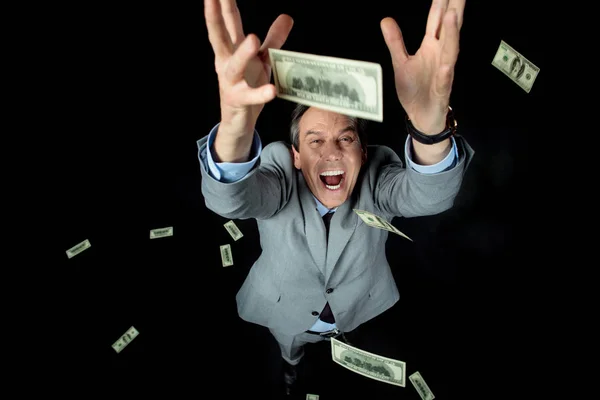 Businessman catching dollars — Stock Photo, Image