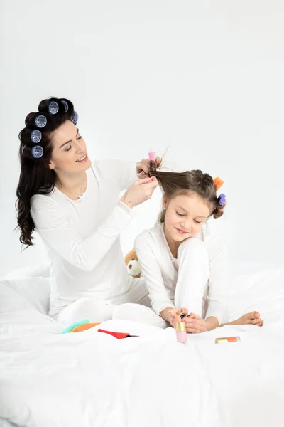 Mother and daughter in curlers — Stock Photo
