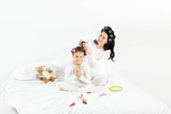 Mother and daughter in curlers — Stock Photo