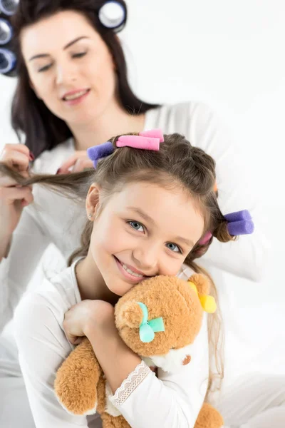 Mother and daughter in curlers — Stock Photo