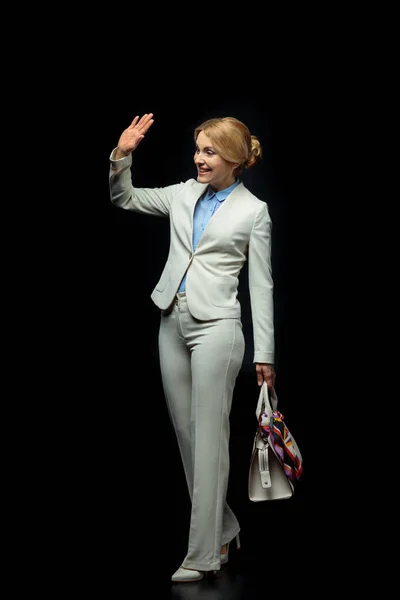 Blonde businesswoman waving — Stock Photo