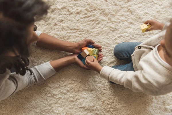 Mother and daughter playing with cubes Stock Photo