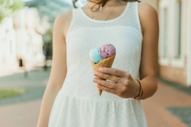 Young woman eating ice cream  clipart