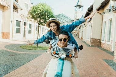 Young couple riding scooter  clipart
