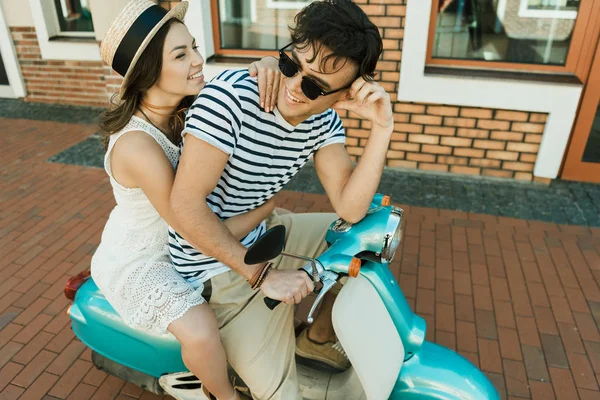 Young couple riding scooter — Stock Photo, Image