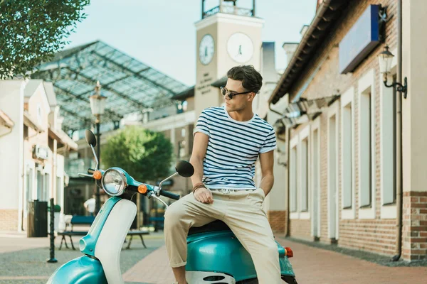 Man sitting on scooter — Stock Photo, Image