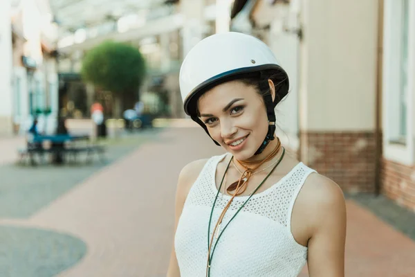 Lachende vrouw in helm camera kijken — Gratis stockfoto